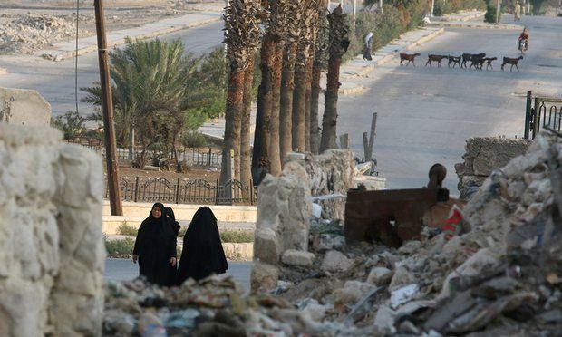 Women walk through the rubble of a neighbourhood in Aleppo, Syria, 30 August 2016. Photograph: Abdalrhman Ismail/Reuters