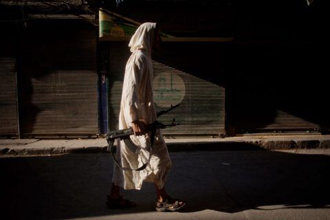 An FSA fighter walks through a street in the Bustan al-Qsar district in Aleppo, Syria, Wednesday, Sept. 12, 2012. (AP Photo/ Manu Brabo)