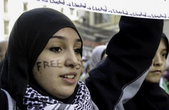 A young women demonstrates against violence in Syria. Women have led protests, delivered humanitarian relief, documented human rights violations, and negotiated with local and national decision makers, among other activities.