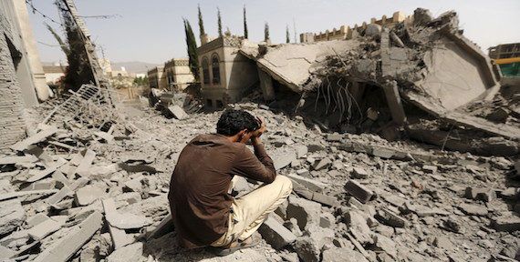 A guard sits on the rubble of the house of Brigadier Fouad al-Emad, an army commander loyal to the Houthis, after air strikes destroyed it in Sanaa, Yemen June 15, 2015. (Reuters/Khaled Abdullah)