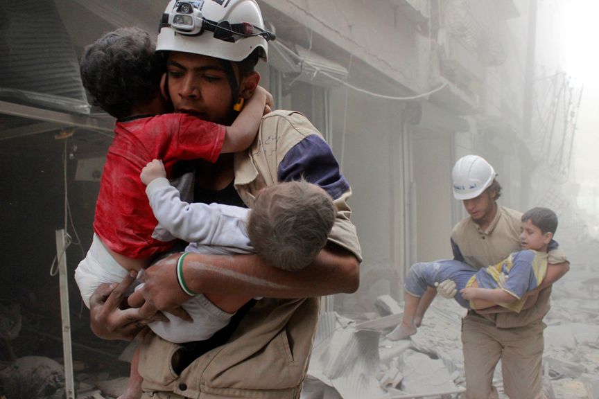 Members of the Civil Defence rescue children after what activists said was an air strike by forces loyal to Syria's President Bashar al-Assad in al-Shaar neighbourhood of Aleppo June 2, 2014. (Sultan Kitaz/Reuters)