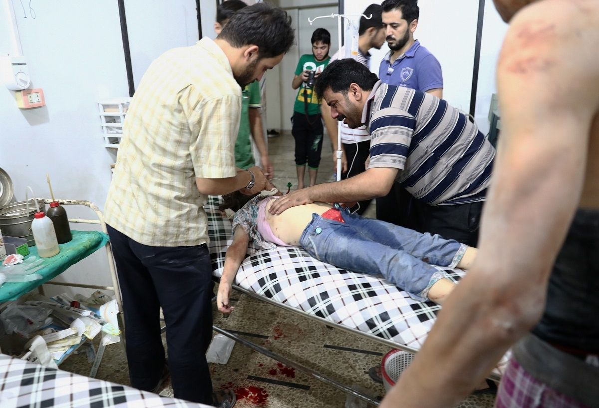 A Syrian man stands next to his daughter as she receives treatment at a makeshift hospital following a reported air stike on the rebel-held town of Douma, east of the capital Damascus, on August 23, 2016. A Syrian man stands next to his daughter as she receives treatment at a makeshift hospital following a reported air stike on the rebel-held town of Douma, east of the capital Damascus, on August 23, 2016.
